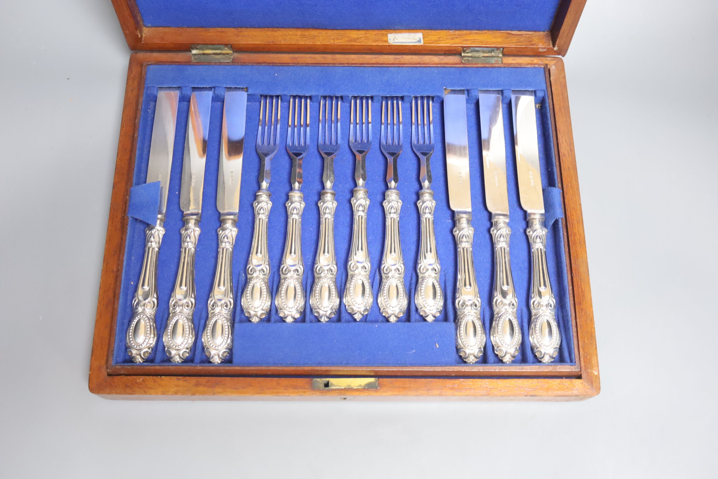 A cased set of twelve plated dessert knives and forks